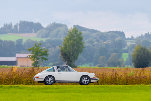 Salgen, Germany - September 25, 2022: 1970 Porsche 911 Targa german oldtimer vintage luxury sports car in a picturesque landscape.
