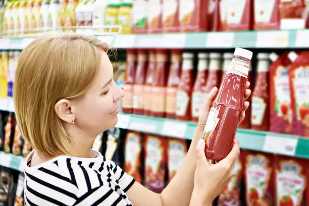 Photo of Tomato ketchup in hands woman