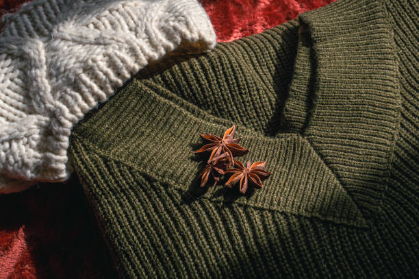 Army green woolen sweater and white woolen hat stock photo