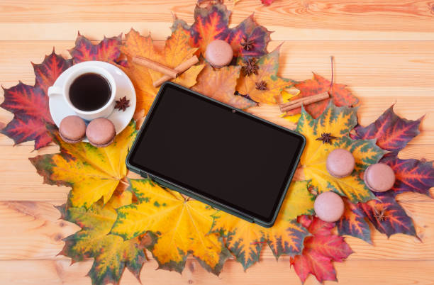 istock Autumn composition. Tablet, cup of coffee and autumn maple leaves. 1428449418
