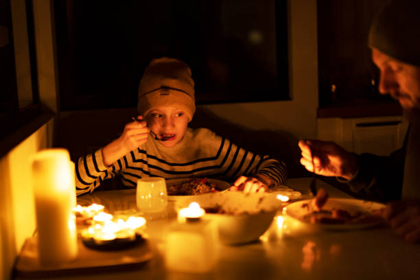istock Family eating with candles during blackout 1428450788