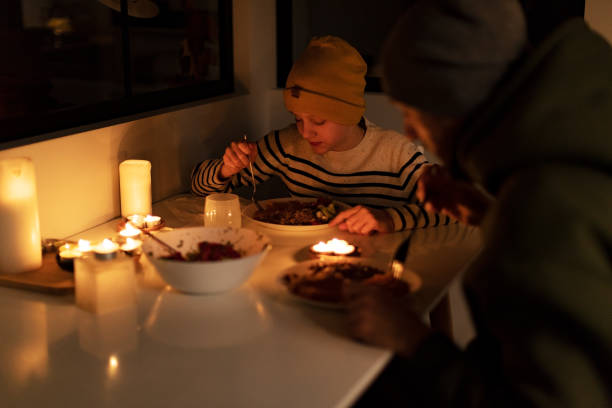 istock Family eating with candles during blackout 1428450813