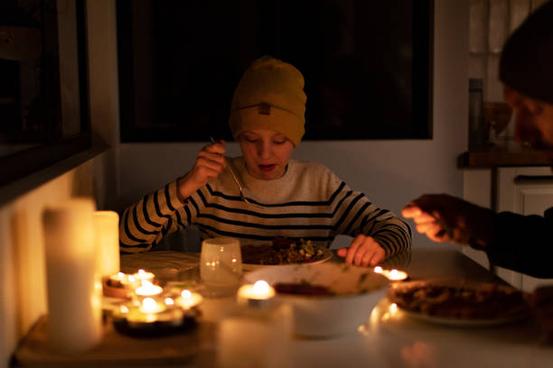 istock Family eating with candles during blackout 1428450814