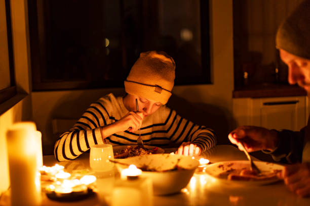 istock Family eating with candles during blackout 1428450820