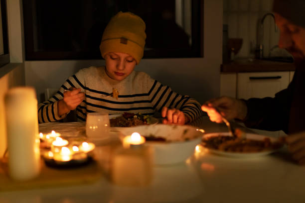 istock Family eating with candles during blackout 1428450825