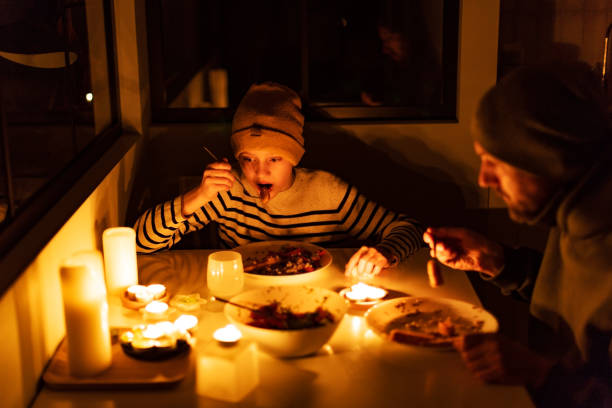 istock Family eating with candles during blackout 1428450829