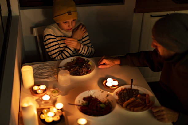 istock Family eating with candles during blackout 1428450830