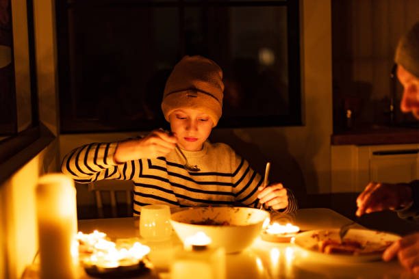 istock Family eating with candles during blackout 1428450834