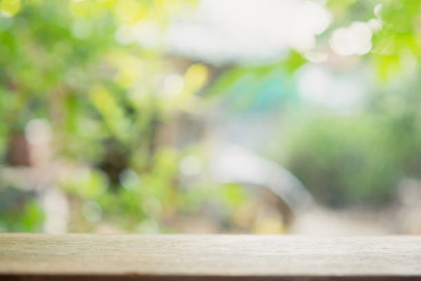 istock Empty wood table top and blur nature background with copy space for display or montage your products 1428452235