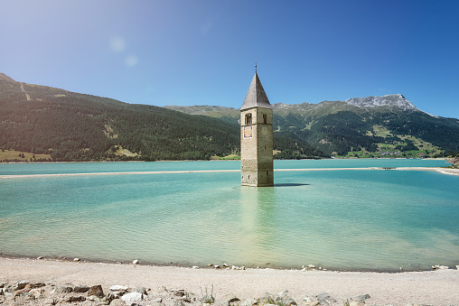 Reschensee, Lago di Resia or Lake Reschen is an artificial lake in the western portion of South Tyrol, Italy. The sunken church gives a really bizarre view.