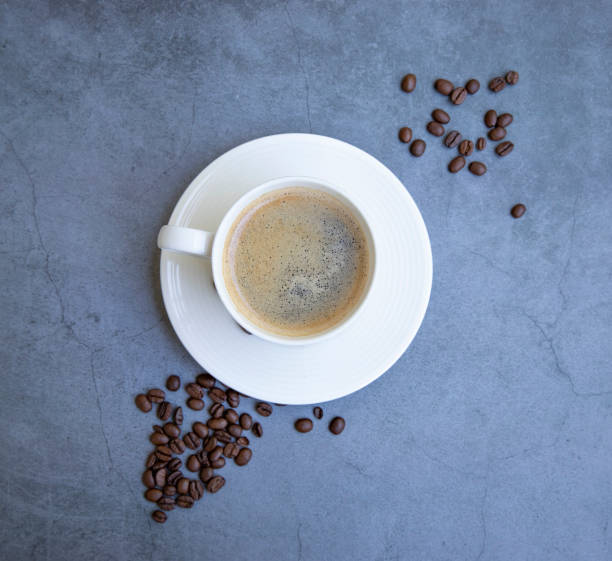 istock white coffee mug and coffee beans on gray background 1428454315