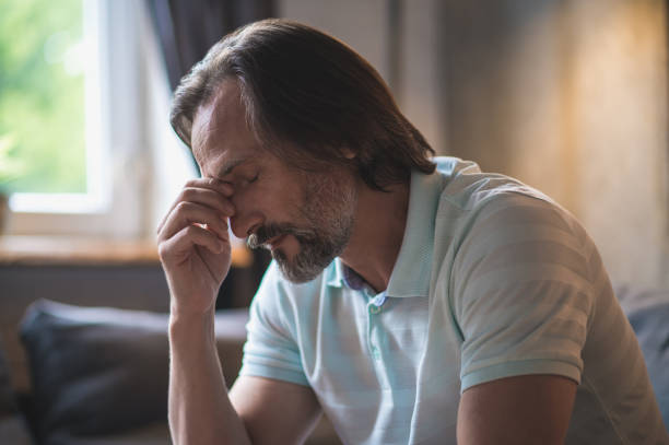 istock Mature bearded man sitting with a thoughtful look 1428462780