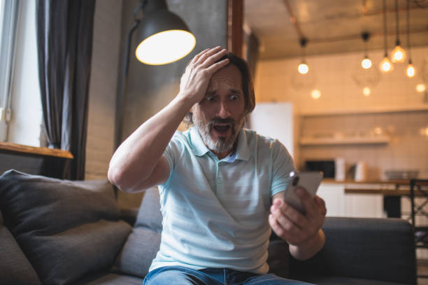 istock Mature man spending time at home and watching something on his smartphone 1428462804