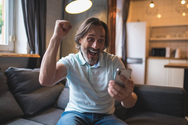 istock Mature man spending time at home and watching something on his smartphone 1428462837