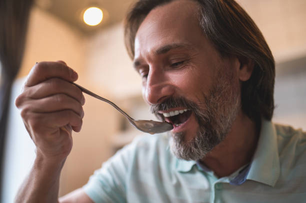 istock Mature caucasian man sitting at the table and eating breakfast 1428462858