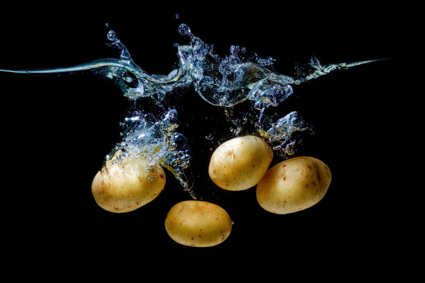 istock Fresh potatoes falling in water with splashes 1428468350