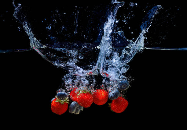 istock Blueberries and strawberries dropped in water 1428468456