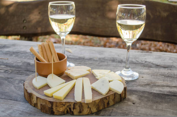 istock Goat cheese and white wine sampler served on a wooden board 1428483068