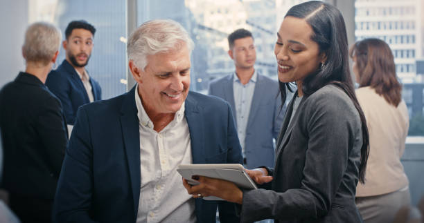 istock Meeting, business man and personal assistant with tablet showing ceo, leader or boss work schedule for the day. Professional black woman with senior executive planning presentation strategy for team 1428484116