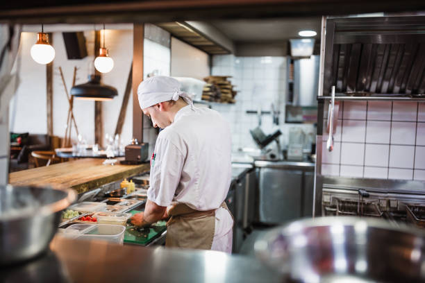 istock Junior chef preparing food ingredients for Chefs final touch 1428484255