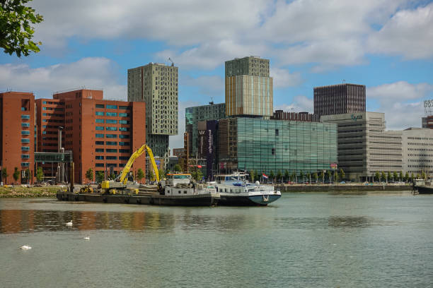Dredging in front of Hogeschool builidngs on Posthumalaan, Rotterdam, Netherlands stock photo