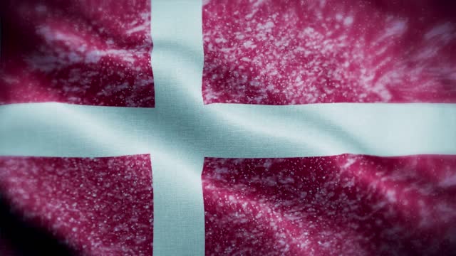 4K blizzard / snow over Denmark flag stock video. Frosty Danish flag. Whirling / swirling ice crystals. Snowflakes flitting over Dane flag.