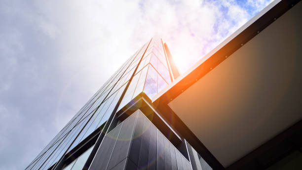 istock Glass clad facade of a modern skyscraper covered in reflective plate glass. 1428505413