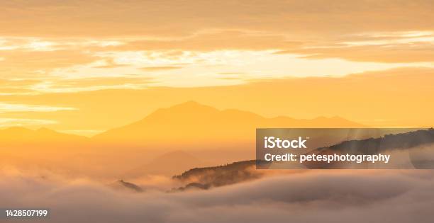 Golden Sunrise Above A Sea Of Clouds And Mountains Stock Photo - Download Image Now - Japan, Cloud - Sky, Cloudscape
