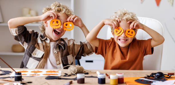 istock Cute children  boys making Halloween home decorations 1428510484