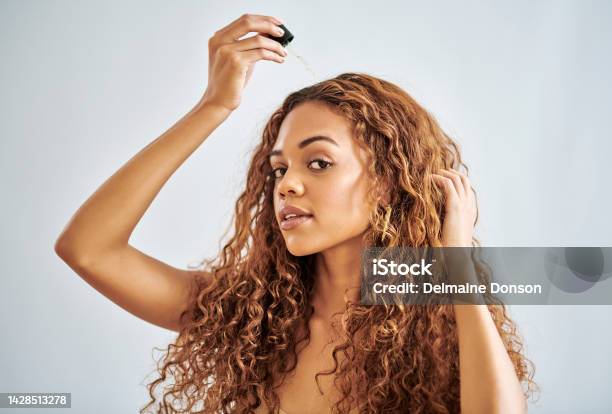 Black Woman Beauty And Hair Care With Serum Dropper For Treatment And Repair Against A Grey Studio Background Beautiful African Female Model In Haircare With Cosmetic Oil Pipette For Healthy Scalp Stock Photo - Download Image Now