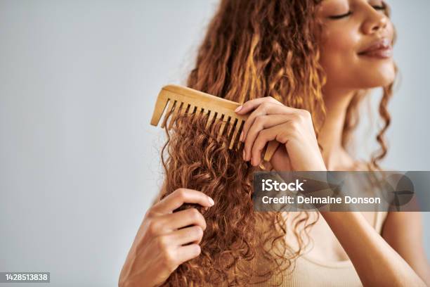 Hair Care Beauty And Woman Brushing Her Curly Hair With A Wooden Comb  During Her Self