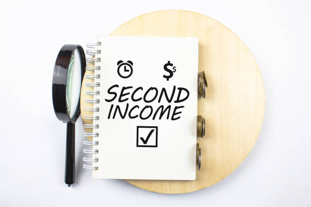 istock Second income concept. Second income inscription on a notepad next to money, dollar and clock symbol.Search for a part-time job.Successful profit,hobby income. 1428524628