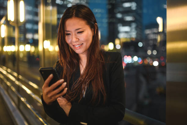 istock Young Asian Woman Reading Emails And Working With A Smart Phone While Commuting 1428526991
