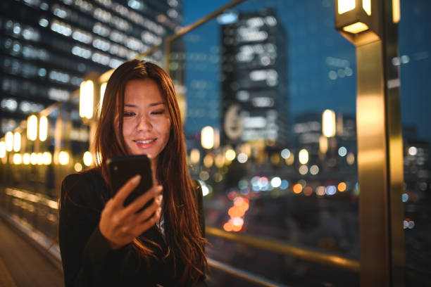 istock Busy Asian Woman Using A Smart Phone While Commuting In The City 1428526999