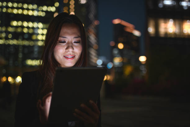 istock Busy Asian Woman Working Outdoors With A Digital Tablet At Night 1428527561