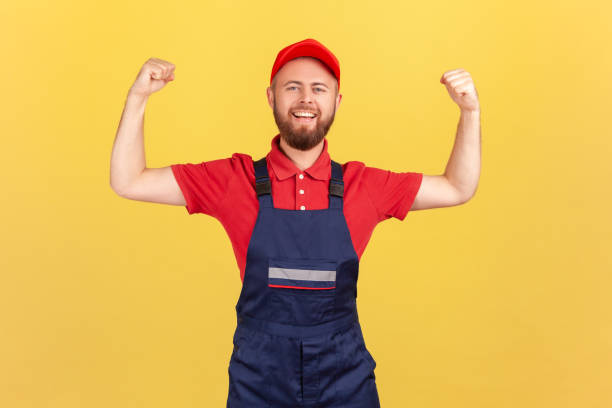 istock Worker man standing with raised arms and showing his power, looking at camera with pride. 1428532101