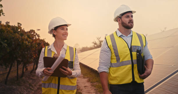 istock Energy, sustainability and solar panel engineer planning and talking, sharing vision and goal for renewable energy. Design, mission and man and woman happy, excited with innovation and electricity 1428532181