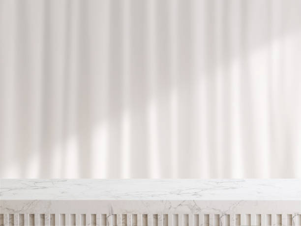 Marble tabletop or countertop and white curtain with sunlight from window in background