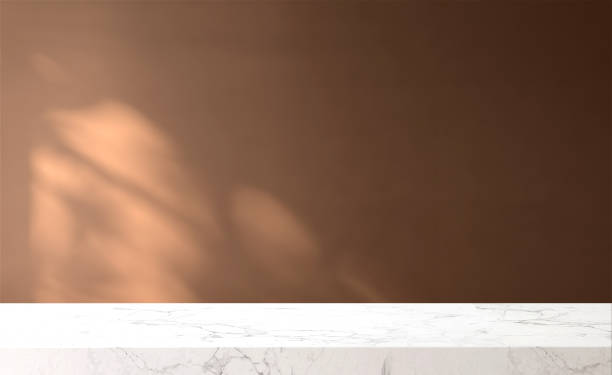 istock White marble tabletop or countertop in modern and minimal brown wall room with sunlight and tree shadow from window at home 1428544430