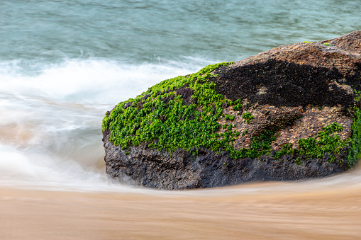 Stone in the water at Red Beach Urca in Rio de Janeiro Brazil.