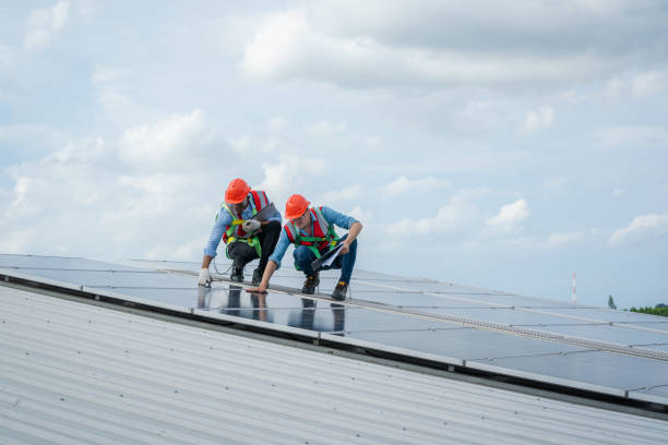 istock Technician wearing safety harness belt during installing the solar panels. 1428553500