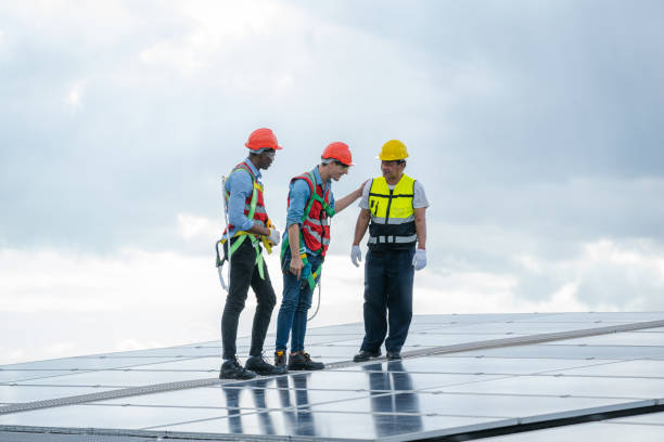 istock Technician wearing safety harness belt during installing the solar panels. 1428553514