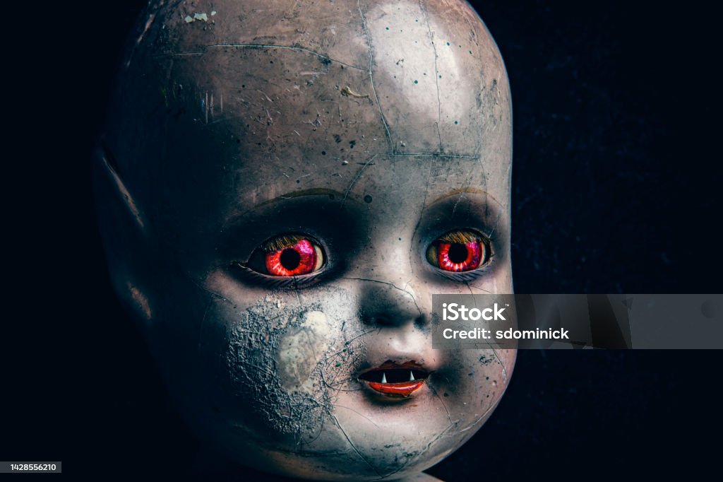 Creepy Horror Demon Baby Doll A close up of a creepy baby doll that look like a little demon. Monster - Fictional Character Stock Photo