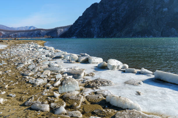 istock Seascape with white ice on a sandy beach 1428557646