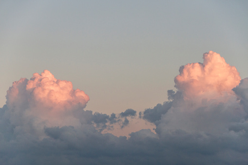 Clouds in pink above darker blue cloud. Copy Space available.