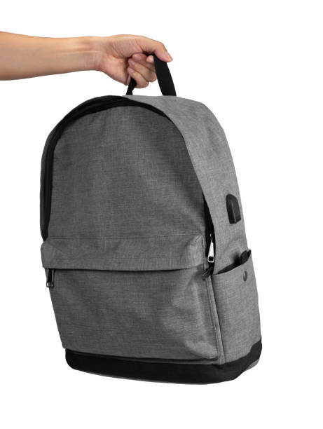 istock Hand holding gray color backpack isolated on white 1428561797