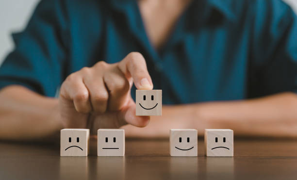 istock Satisfaction survey concept. Customer services best excellent business rating experience. Hand of business chooses a smile face on wood block circle. 5 Star Satisfaction. People feel great product. 1428562163