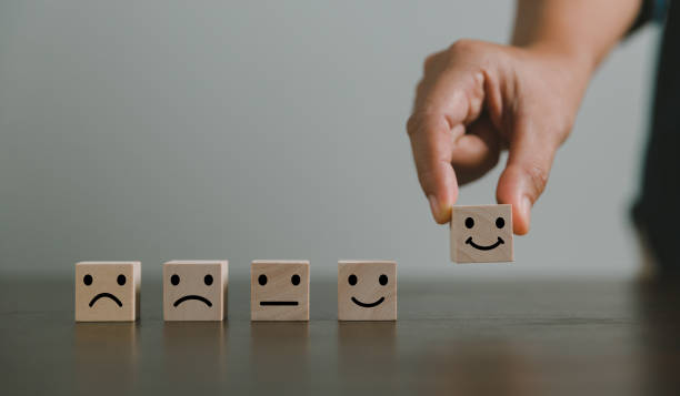 istock Satisfaction survey concept. Customer services best excellent business rating experience. Hand of business chooses a smile face on wood block circle. 5 Star Satisfaction. People feel great product. 1428562272