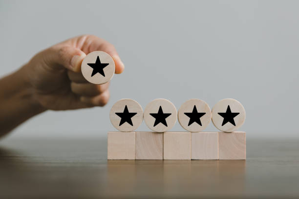 istock Satisfaction survey concept. Customer services best excellent business rating experience. Hand of business chooses a smile face on wood block circle. 5 Star Satisfaction. People feel great product. 1428562304