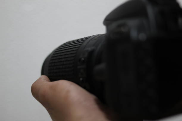 istock Photographer holding a professional black digital photo camera. 1428562646